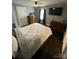 This bedroom features hardwood floors, neutral gray paint, a ceiling fan, and coordinating furniture at 621 N Craige St # 25 & 27, Salisbury, NC 28144