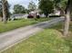 Paved driveway with home, manicured lawn and mature trees, creating an inviting curb appeal at 621 N Craige St # 25 & 27, Salisbury, NC 28144