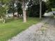 Gravel driveway, leads to a home partially obscured by trees, offering a sense of privacy and seclusion at 621 N Craige St # 25 & 27, Salisbury, NC 28144