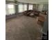 Spacious living room featuring neutral carpet, several windows, and comfortable seating, perfect for relaxation at 621 N Craige St # 25 & 27, Salisbury, NC 28144