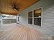 Covered porch featuring wooden flooring and outdoor lighting at 6803 Ware Rd, Charlotte, NC 28212