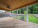 Back porch features wooden flooring and a ceiling fan overlooking the backyard at 6803 Ware Rd, Charlotte, NC 28212
