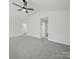 Large bedroom with neutral carpeting and a ceiling fan at 6803 Ware Rd, Charlotte, NC 28212