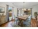 Dining room with hardwood flooring, chandelier and light blue upholstered chairs at 6803 Ware Rd, Charlotte, NC 28212
