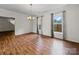 Open dining room with hardwood floors, large windows and hanging chandelier at 6803 Ware Rd, Charlotte, NC 28212