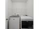 Functional laundry area featuring modern machines and wire shelving at 6803 Ware Rd, Charlotte, NC 28212