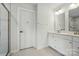 Clean bathroom with a double vanity, wall mirror, shower with tile surround, and door to toilet at 812 Dogwood Creek Ln, Indian Trail, NC 28079