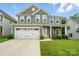 Charming two-story home with a two-car garage, landscaped yard, and inviting front porch at 812 Dogwood Creek Ln, Indian Trail, NC 28079