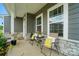 Cozy front porch featuring seating, stone accents, and a welcoming entrance at 812 Dogwood Creek Ln, Indian Trail, NC 28079