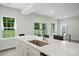 Kitchen island with stainless steel sink and view of the dining and backyard views, plus seating at 812 Dogwood Creek Ln, Indian Trail, NC 28079