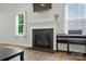 Bright living room featuring a fireplace, natural light from windows, and a nearby piano at 812 Dogwood Creek Ln, Indian Trail, NC 28079