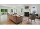 Cozy living room with fireplace, piano, and multiple windows offering natural light and backyard views at 812 Dogwood Creek Ln, Indian Trail, NC 28079