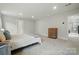 Inviting main bedroom featuring plush carpeting, ensuite bathroom, and bright neutral walls at 812 Dogwood Creek Ln, Indian Trail, NC 28079