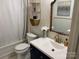 Stylish bathroom featuring modern fixtures, geometric wallpaper, and a sleek vanity with gold hardware at 8421 Coulwood Oak Ln, Charlotte, NC 28214