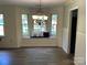 Cozy dining area featuring wainscotting, a bay window seat and modern chandelier at 8421 Coulwood Oak Ln, Charlotte, NC 28214