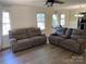 Spacious living room with wood floors, large windows, and comfortable seating at 8421 Coulwood Oak Ln, Charlotte, NC 28214