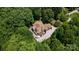 Stunning aerial view of a secluded home surrounded by lush greenery, featuring a large patio and driveway at 849 Savile Ln, Fort Mill, SC 29715