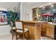 Basement bar area with wood bar, cabinets, popcorn machine, and seating at 849 Savile Ln, Fort Mill, SC 29715