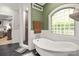 Green Bathroom featuring a clawfoot tub, tile accents, and a glass block window at 849 Savile Ln, Fort Mill, SC 29715