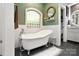 Bathroom featuring a clawfoot tub, tile accents, and a decorative window at 849 Savile Ln, Fort Mill, SC 29715