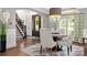 Formal dining room featuring wainscoting, a glass table, and view of the foyer at 849 Savile Ln, Fort Mill, SC 29715