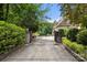 Gated driveway leading to a private home, framed by mature trees and manicured greenery at 849 Savile Ln, Fort Mill, SC 29715