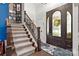 Welcoming foyer with staircase, hardwood floors, and a decorative front door at 849 Savile Ln, Fort Mill, SC 29715