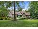 Charming brick home with lush front lawn, mature trees, and manicured landscaping at 849 Savile Ln, Fort Mill, SC 29715