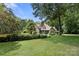 Two story brick home with a well manicured lawn and many trees at 849 Savile Ln, Fort Mill, SC 29715