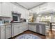 Bright kitchen with white cabinets, stainless steel appliances, and hardwood floors at 849 Savile Ln, Fort Mill, SC 29715