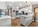 Modern kitchen featuring stainless steel appliances, custom cabinets, stylish lighting, and a stone backsplash wall at 849 Savile Ln, Fort Mill, SC 29715