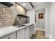 A stainless steel sink is framed by tile backsplash and white marble countertops at 849 Savile Ln, Fort Mill, SC 29715