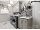 Laundry room with modern appliances, grey cabinetry, and a sink at 849 Savile Ln, Fort Mill, SC 29715