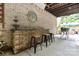 Covered outdoor bar featuring a stone counter, three stools, and brick wall at 849 Savile Ln, Fort Mill, SC 29715