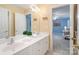 Bathroom featuring double vanity sinks and a doorway leading to a brightly lit bedroom at 9027 Kirkley Ct, Charlotte, NC 28277