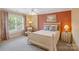 Cozy bedroom featuring neutral colors, a ceiling fan, and a bright window at 9027 Kirkley Ct, Charlotte, NC 28277