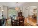 Formal dining room with a large window, stylish lighting, and hardwood flooring at 9027 Kirkley Ct, Charlotte, NC 28277
