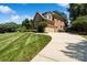 Brick home showing a long drive way, manicured lawn, and side-entry garage at 9027 Kirkley Ct, Charlotte, NC 28277