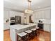Modern kitchen with a large island, stainless steel appliances, and stylish pendant lighting at 9027 Kirkley Ct, Charlotte, NC 28277