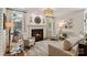 Elegant living room with a fireplace, patterned chairs, a neutral sofa, and an area rug at 9027 Kirkley Ct, Charlotte, NC 28277