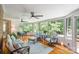 Inviting sunroom featuring hardwood floors, multiple ceiling fans, and abundant natural light at 9027 Kirkley Ct, Charlotte, NC 28277