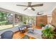 Inviting sunroom with brick accents, wood flooring, and comfortable seating at 9027 Kirkley Ct, Charlotte, NC 28277