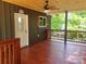 Charming covered deck with wood flooring and ceiling fan, creating a cozy outdoor living space at 94 James Sw St, Concord, NC 28025