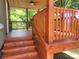 Back porch with wood flooring, steps, and views of the wooded surroundings at 94 James Sw St, Concord, NC 28025