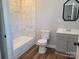 Bathroom featuring a modern vanity, toilet, and a tiled shower and bathtub combo at 94 James Sw St, Concord, NC 28025