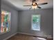 Bedroom with two windows offering natural light and a ceiling fan for added comfort at 94 James Sw St, Concord, NC 28025
