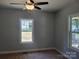 Bedroom with carpet, grey walls, and windows providing natural light and neighborhood views at 94 James Sw St, Concord, NC 28025
