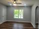 A large bedroom with wood-look flooring and a ceiling fan for added comfort at 94 James Sw St, Concord, NC 28025