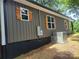 A home exterior highlights the modern siding and wooden shutters, adding to the property's charm at 94 James Sw St, Concord, NC 28025