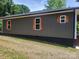 Home exterior shows newly done siding and charming wood shutters, enhancing its curb appeal and character at 94 James Sw St, Concord, NC 28025